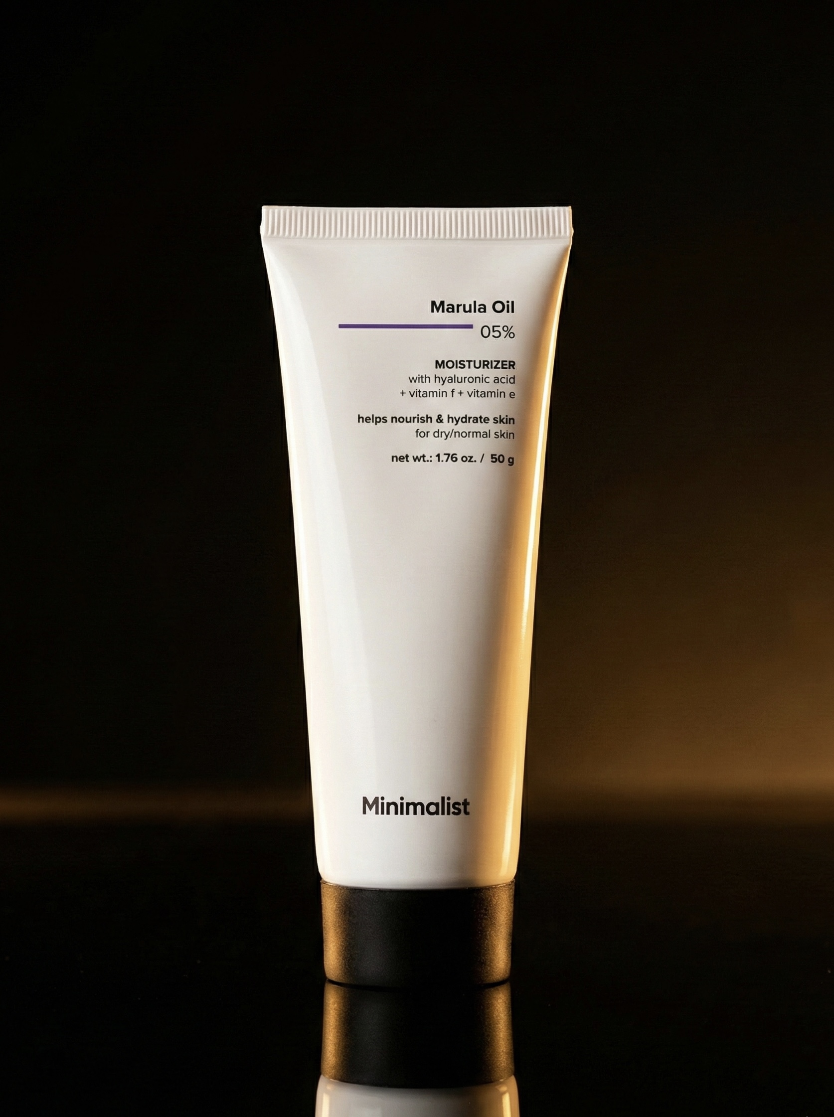 Minimalist marula oil moisturiser on dark gold surface
